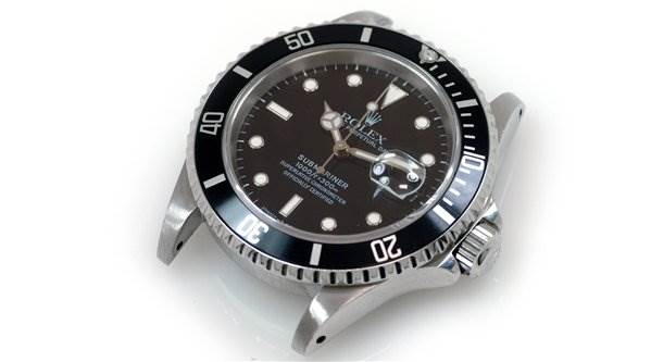 The Rolex Submariner 16610 Men's Stainless Steel Black Dial 16610 Men's Stainless Steel Black Dial watch is shown at a slight angle from above, highlighting its bezel, crown, and dial.