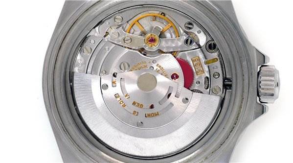 This image shows the back view of a Rolex Submariner 16610 Men's Stainless Steel Black Dial 16610 Men's Stainless Steel Black Dial watch, highlighting its intricate mechanical movement.