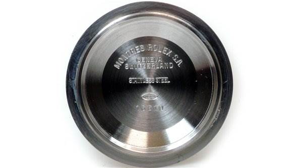 This image shows the inside of the case back of a Rolex Submariner 16610 Men's Stainless Steel Black Dial 16610 Men's Stainless Steel Black Dial watch, displaying engravings and markings.