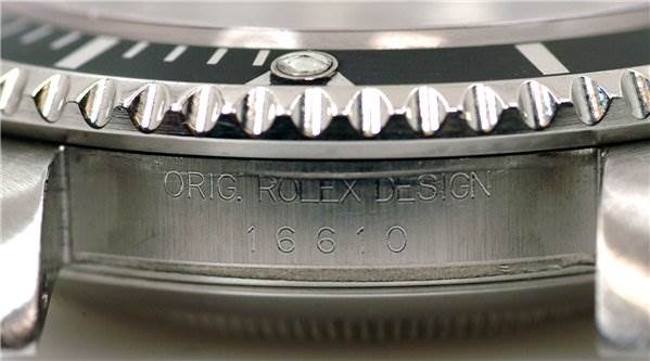 The image shows a close-up of the side of a Rolex Submariner 16610 Men's Stainless Steel Black Dial 16610 Men's Stainless Steel Black Dial watch, highlighting the bezel and engraved model number 16610.