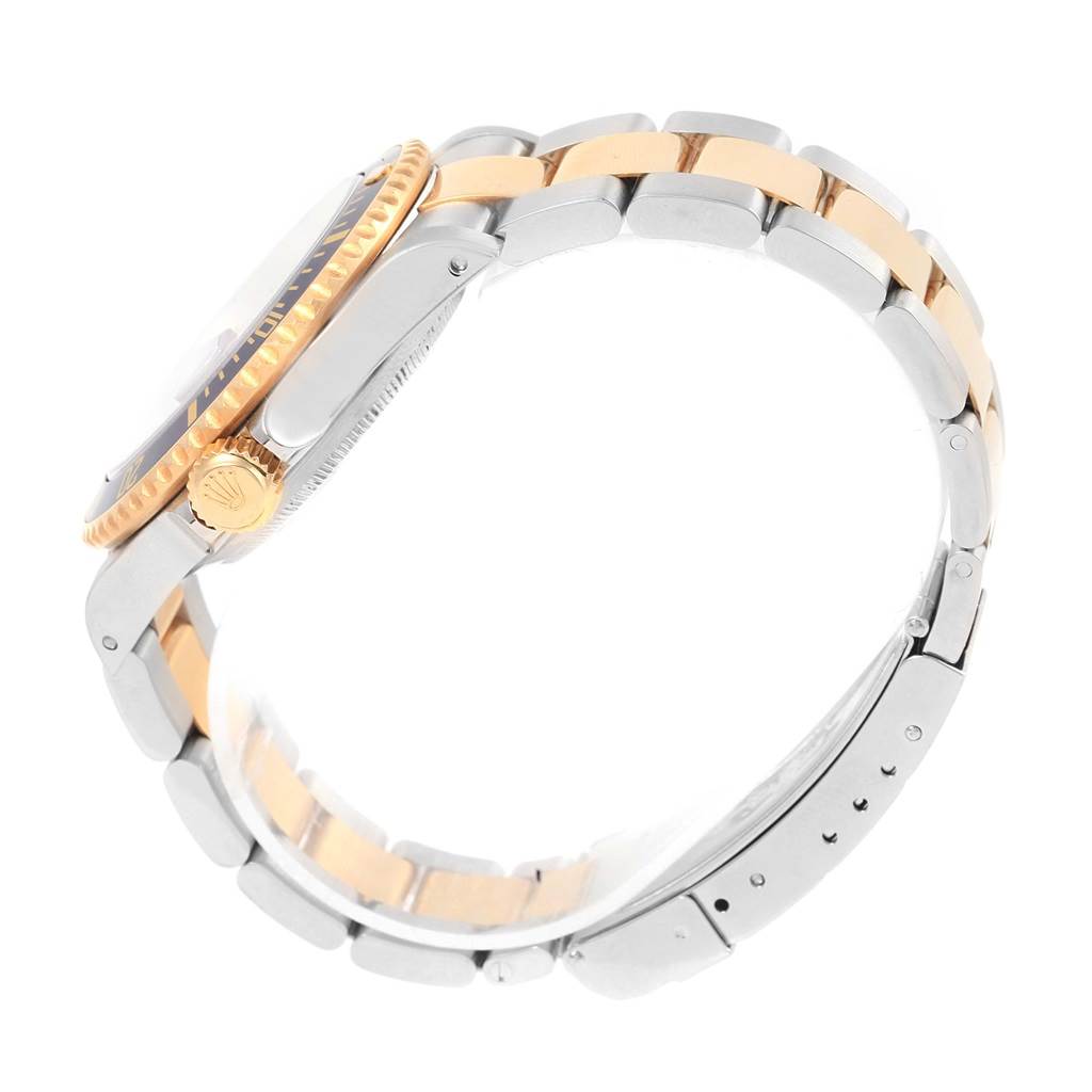 This image shows a side view of a Rolex Submariner 16613 Men's Steel and Gold (two tone) Blue Dial 16613 Men's Steel and Gold (two tone) Blue Dial watch, highlighting its case, crown, and two-toned bracelet.