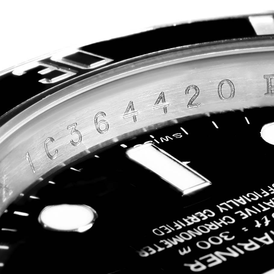 This close-up image shows the rehaut engraving and part of the dial of a Rolex Submariner 114060 Men's Stainless Steel Black Dial 114060 Men's Stainless Steel Black Dial watch.