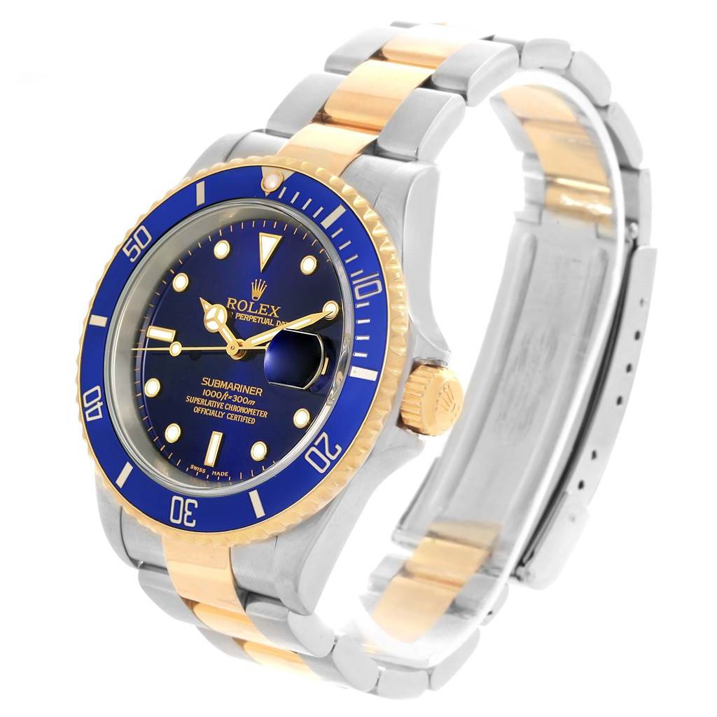 The image shows a Rolex Submariner 16613 Men's Steel and Gold (two tone) Blue Dial 16613 Men's Steel and Gold (two tone) Blue Dial from a three-quarter angle, highlighting its blue dial, date window, and bi-color metal bracelet.