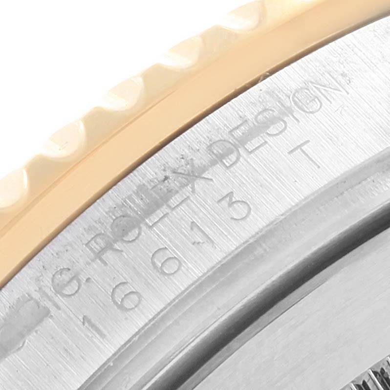 This close-up image shows the bezel and engraved case side of a Rolex Submariner 16613 Men's Steel and Gold (two tone) Blue Dial 16613 Men's Steel and Gold (two tone) Blue Dial, highlighting model details.