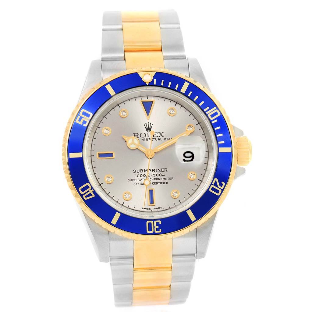 The image shows a front view of the Rolex Submariner 16613 Men's Steel and Gold (two tone) Grey Dial 16613 Men's Steel and Gold (two tone) Grey Dial watch, highlighting its blue bezel, dial, and two-tone bracelet.