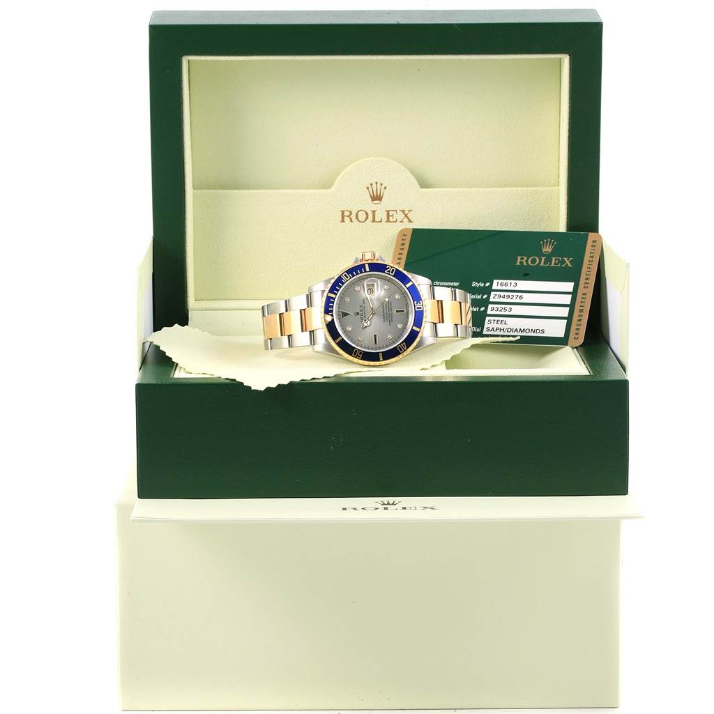 The image shows a Rolex Submariner 16613 Men's Steel and Gold (two tone) Grey Dial 16613 Men's Steel and Gold (two tone) Grey Dial watch at a frontal angle, displayed in an open green box with authenticity cards beside it.
