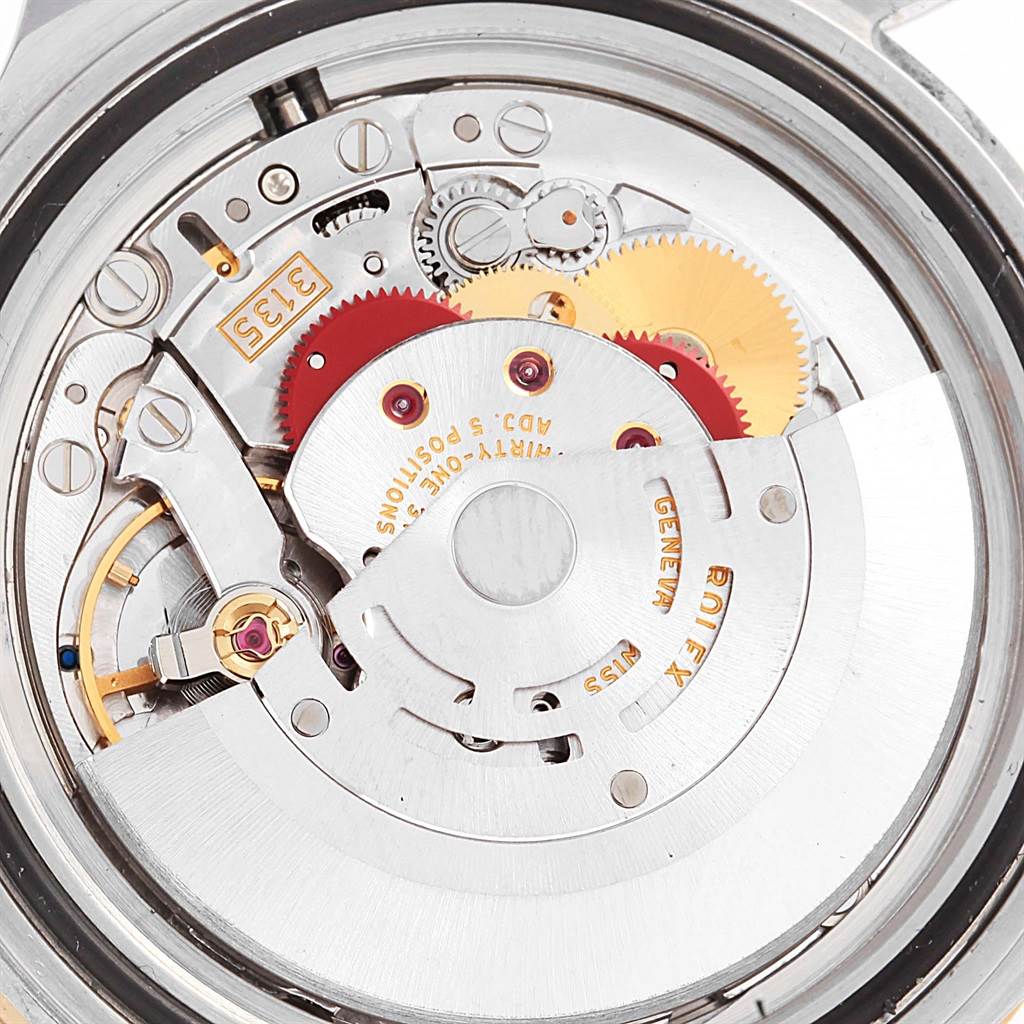 The image shows the intricate internal mechanism of a Rolex Submariner 16613 Men's Steel and Gold (two tone) Grey Dial 16613 Men's Steel and Gold (two tone) Grey Dial watch from the back angle.