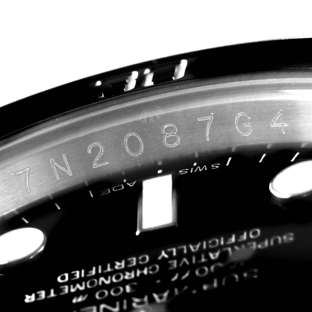 The image shows a close-up of the inner bezel with an engraving of the serial number on a Rolex Submariner 116610 Men's Stainless Steel Black Dial 116610 Men's Stainless Steel Black Dial watch.
