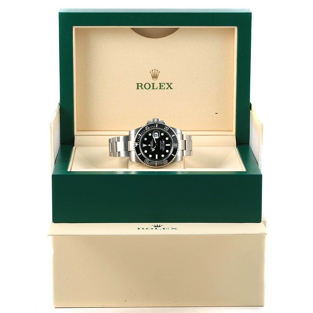 The Rolex Submariner 116610 Men's Stainless Steel Black Dial 116610 Men's Stainless Steel Black Dial watch is shown front-facing in its open green and beige presentation box.