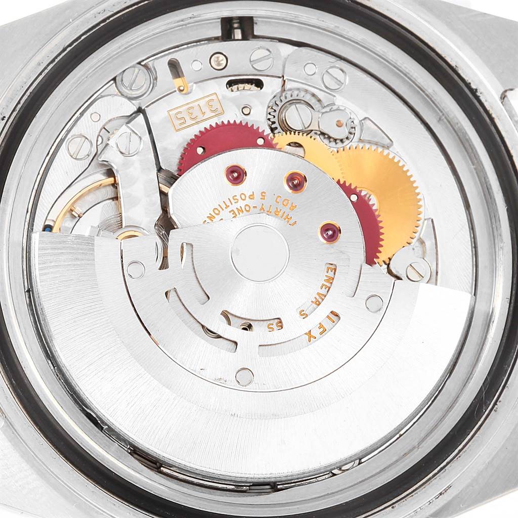 This image shows a close-up of the movement mechanism inside a Rolex Submariner 16610 Men's Stainless Steel Black Dial 16610 Men's Stainless Steel Black Dial watch.