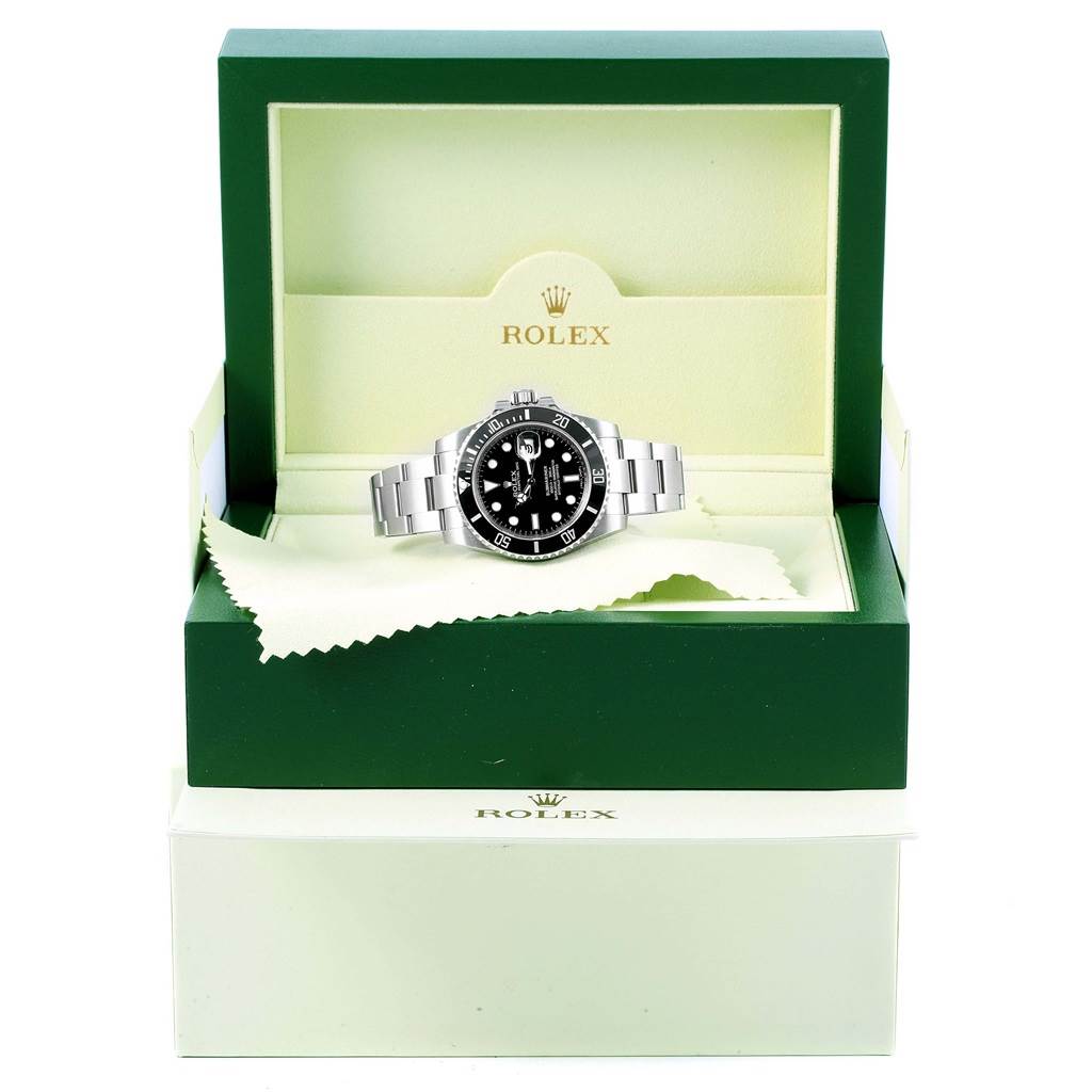 The Rolex Submariner 116610 Men's Stainless Steel Black Dial 116610 Men's Stainless Steel Black Dial watch is displayed front-facing in its open green and cream box.