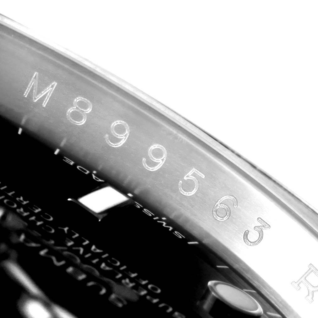 The image shows a close-up of the case rim with the serial number on a Rolex Submariner 16610 Men's Stainless Steel Black Dial 16610 Men's Stainless Steel Black Dial watch.