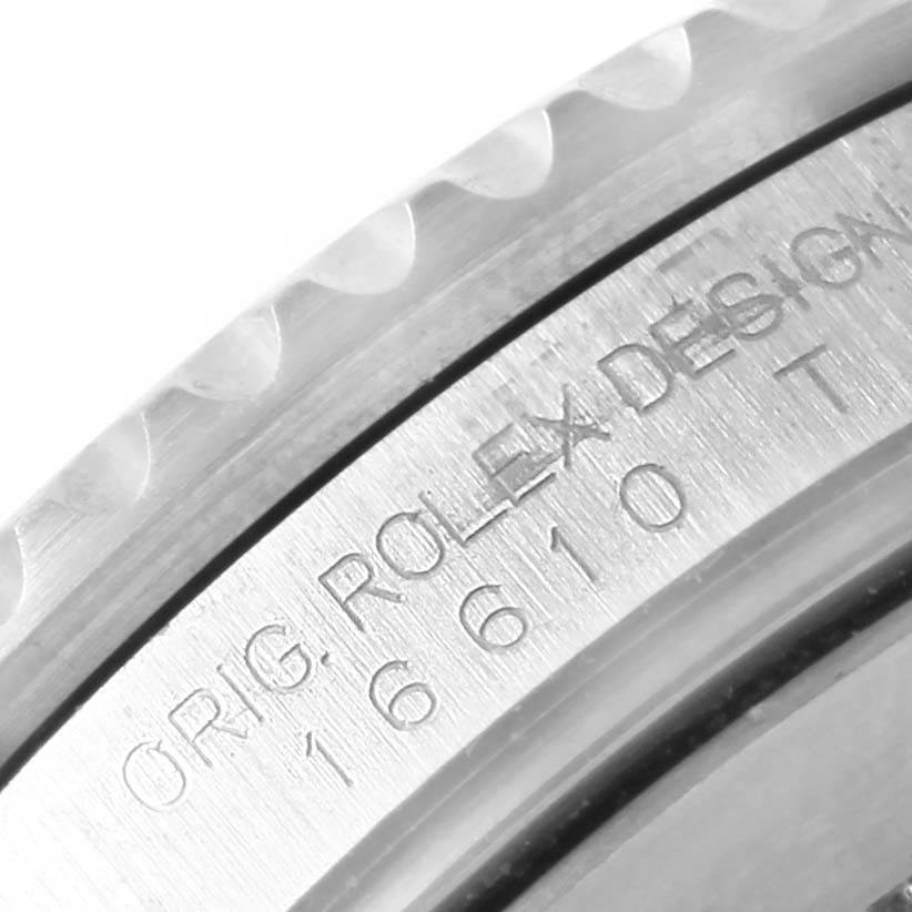 This image shows a close-up of the side-view of a Rolex Submariner 16610 Men's Stainless Steel Black Dial 16610 Men's Stainless Steel Black Dial watch case with engraved text and model number.