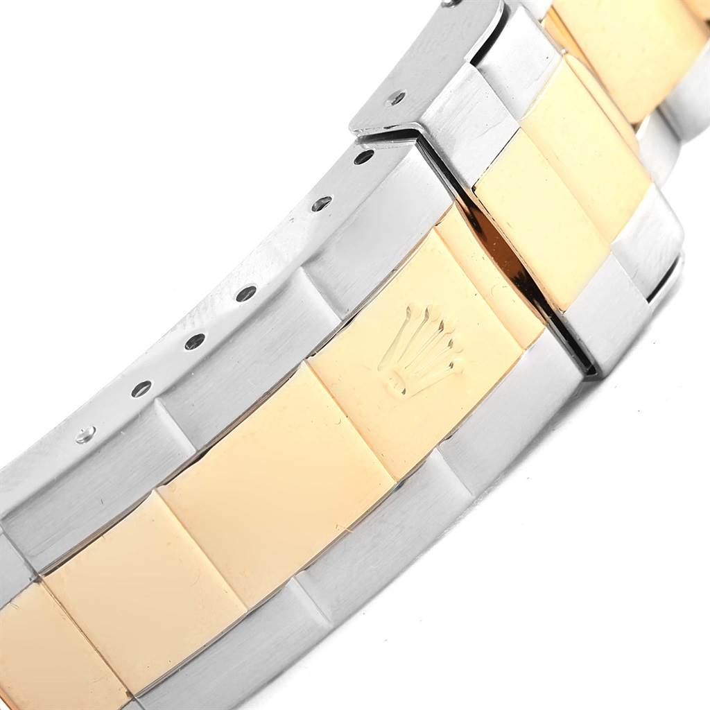 The image shows a close-up of the bracelet of a Rolex Submariner 16613 Men's Steel and Gold (two tone) Blue Dial 16613 Men's Steel and Gold (two tone) Blue Dial model, highlighting the combination of gold and silver links.