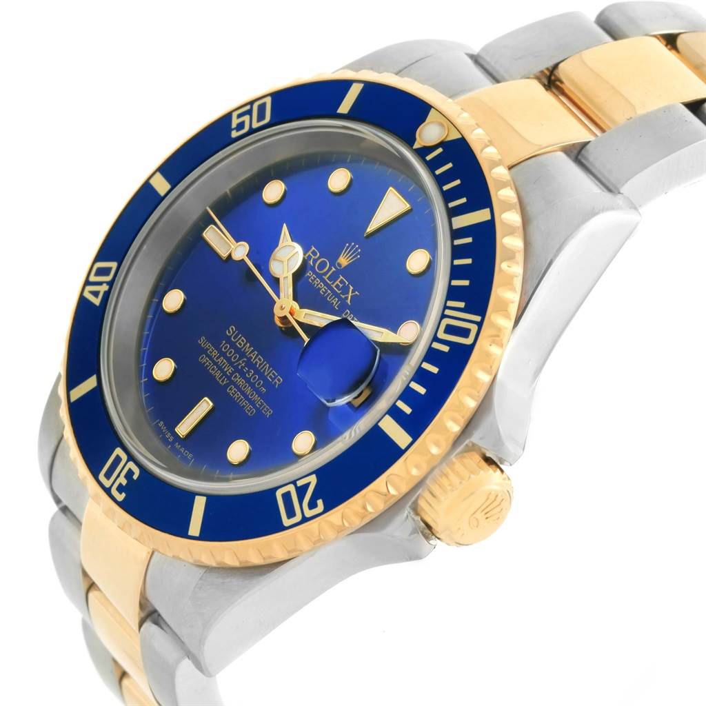 The image shows a Rolex Submariner 16613 Men's Steel and Gold (two tone) Blue Dial 16613 Men's Steel and Gold (two tone) Blue Dial watch from an angled side view, highlighting the dial, bezel, and crown.