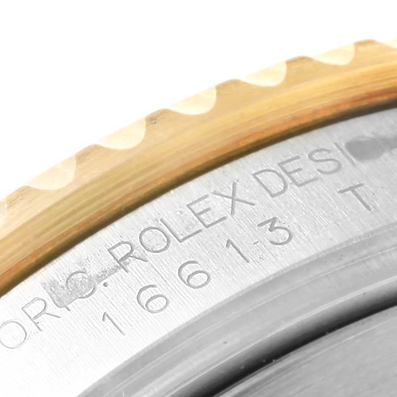 Close-up angle showing the bezel and engraved markings on the case of a Rolex Submariner 16613 Men's Steel and Gold (two tone) Blue Dial 16613 Men's Steel and Gold (two tone) Blue Dial watch.