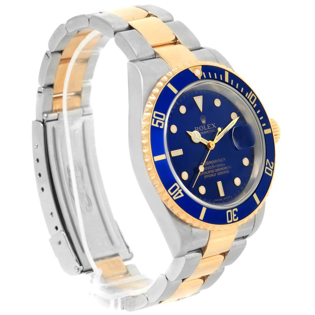 The image shows a Rolex Submariner 16613 Men's Steel and Gold (two tone) Blue Dial 16613 Men's Steel and Gold (two tone) Blue Dial watch angled to display its blue dial, gold bezel, and two-tone metal bracelet.