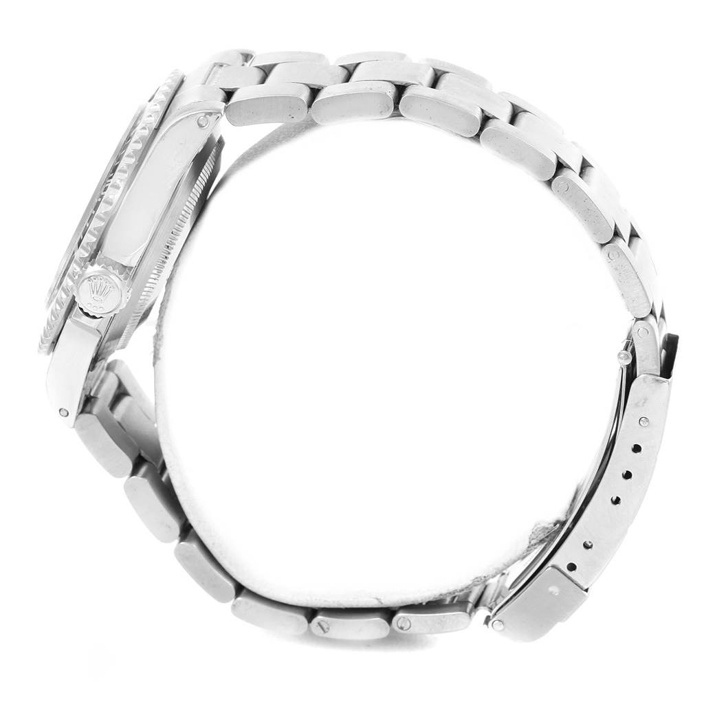 This side-angle image of the Rolex Submariner 14060 Men's Stainless Steel Black Dial 14060 Men's Stainless Steel Black Dial watch shows the bracelet, clasp, case, and crown.