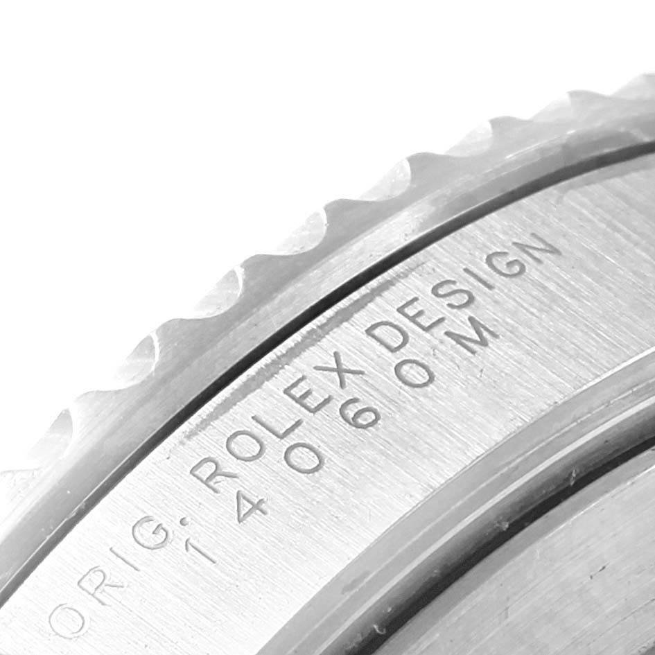 The image shows a close-up of the engraved case back edge and partially the bezel of a Rolex Submariner 14060 Men's Stainless Steel Black Dial 14060 Men's Stainless Steel Black Dial watch model 14060M.