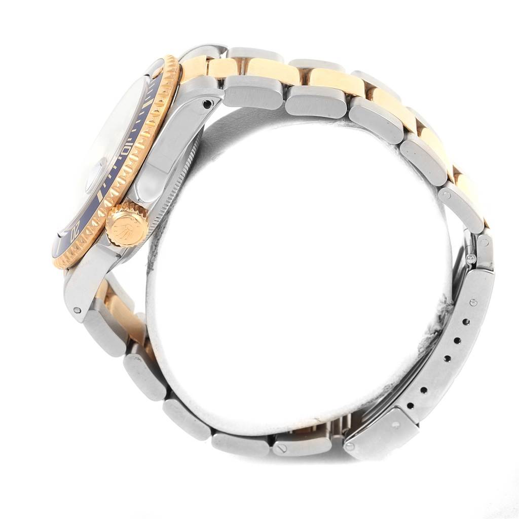 The image shows a side view of the Rolex Submariner 16613 Men's Steel and Gold (two tone) Blue Dial 16613 Men's Steel and Gold (two tone) Blue Dial, highlighting the crown, bezel, and two-tone bracelet.