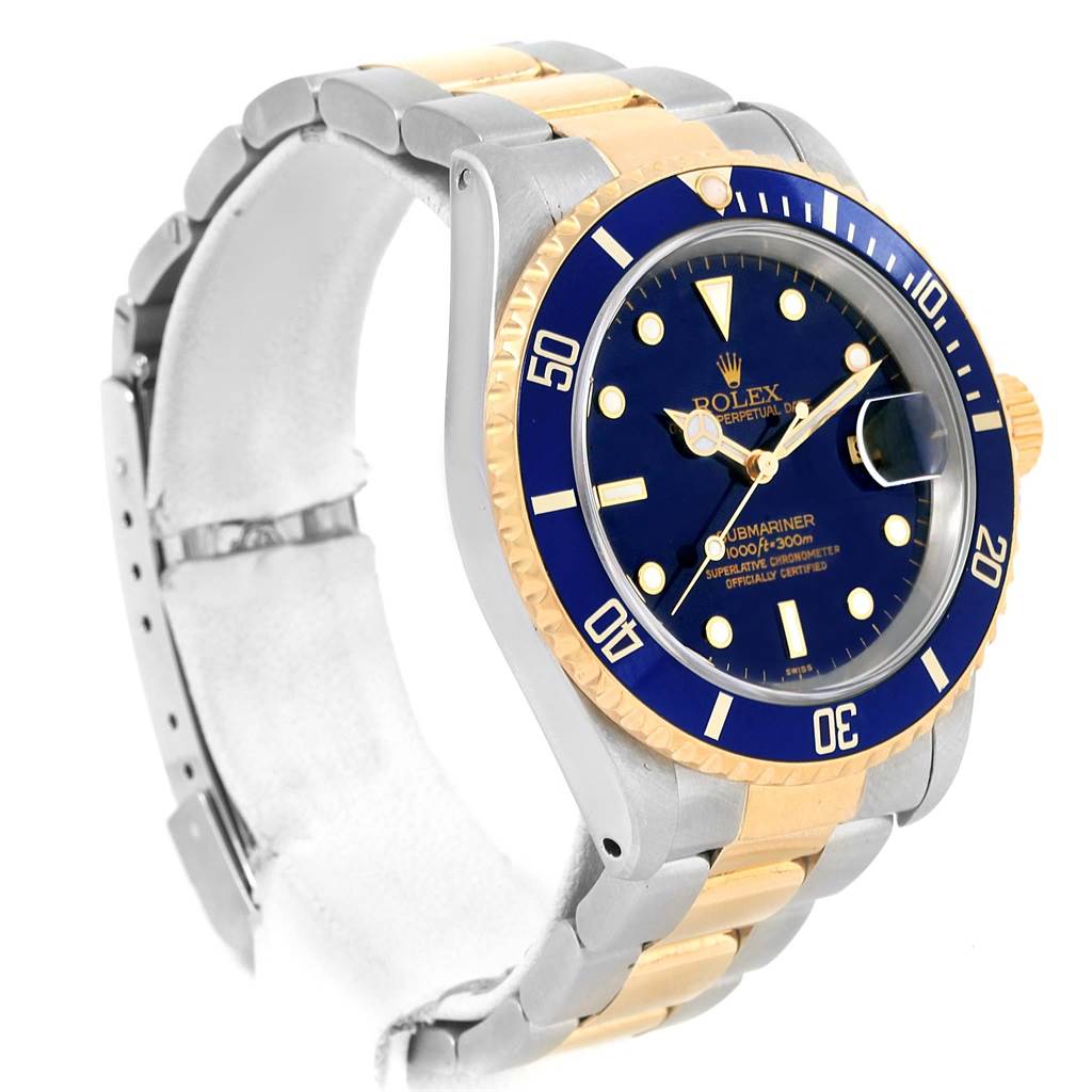 This image shows a Rolex Submariner 16613 Men's Steel and Gold (two tone) Blue Dial 16613 Men's Steel and Gold (two tone) Blue Dial model from an angled view, highlighting its blue dial, bezel, and two-tone metal bracelet.