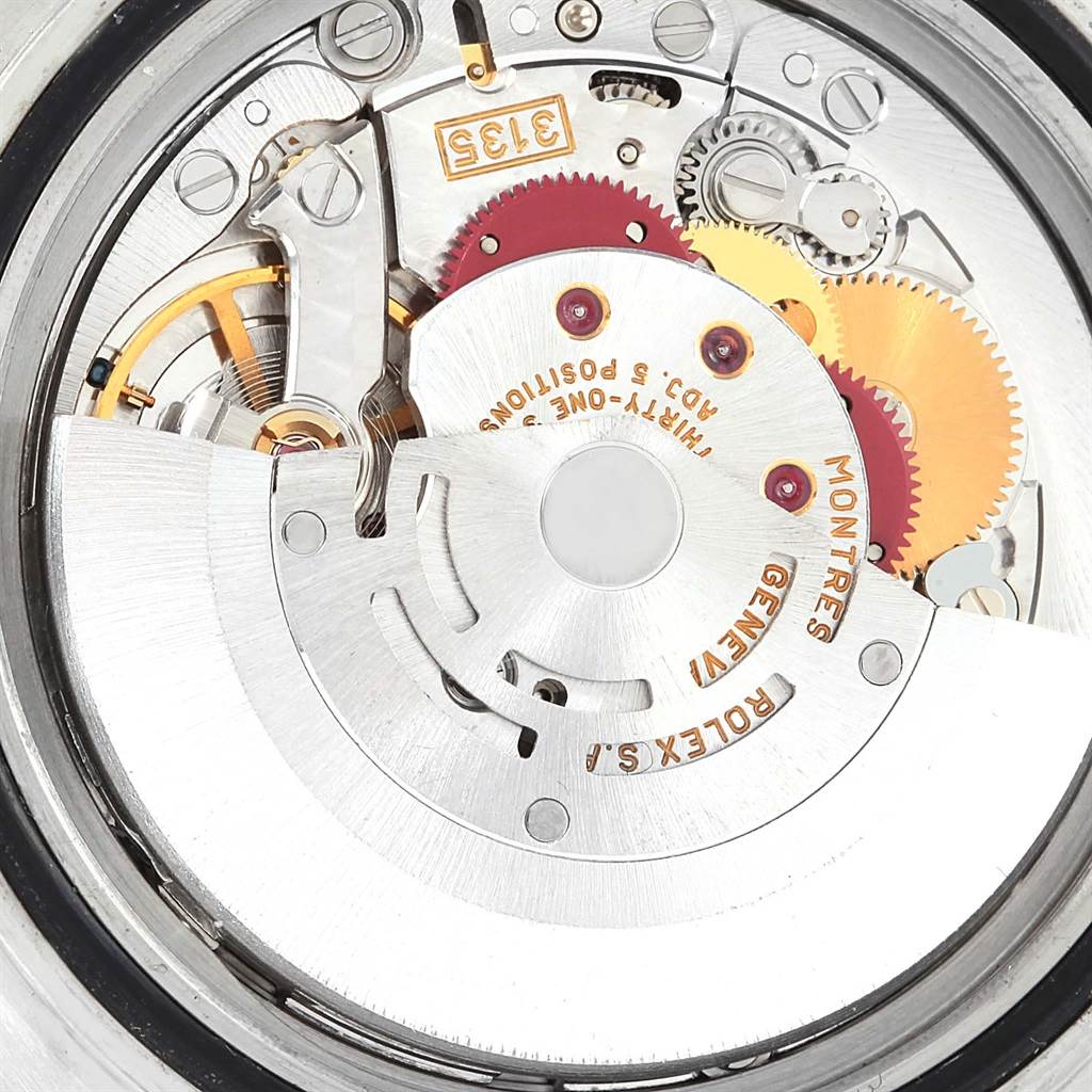 The image shows the intricate internal mechanism of the Rolex Submariner 16613 Men's Steel and Gold (two tone) Blue Dial 16613 Men's Steel and Gold (two tone) Blue Dial watch from a close-up angle.