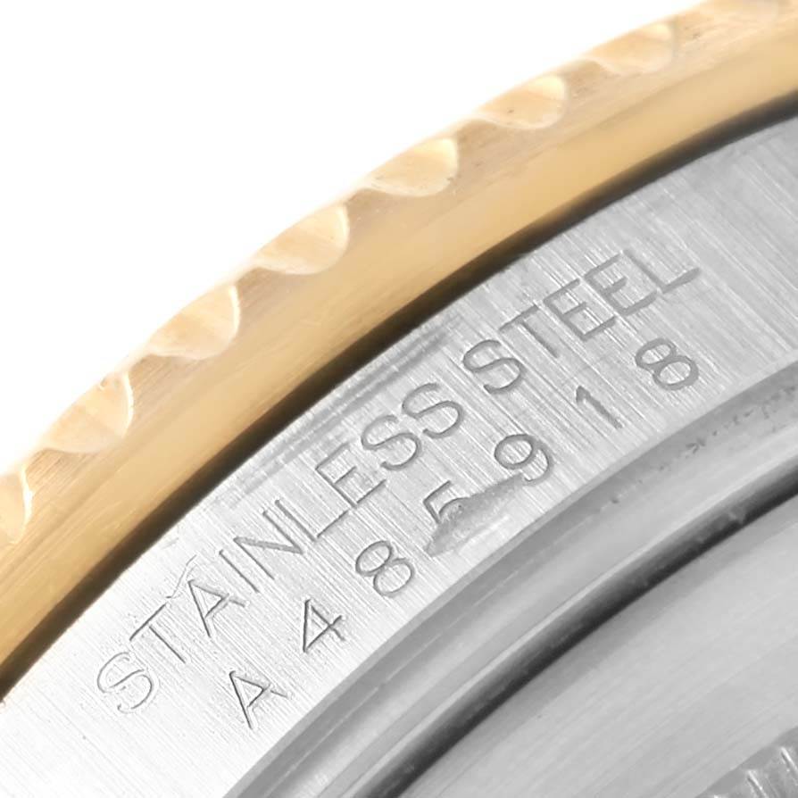 The image shows a close-up of the bezel and case back of a Rolex Submariner 16613 Men's Steel and Gold (two tone) Blue Dial 16613 Men's Steel and Gold (two tone) Blue Dial watch, highlighting the stainless steel engraving.