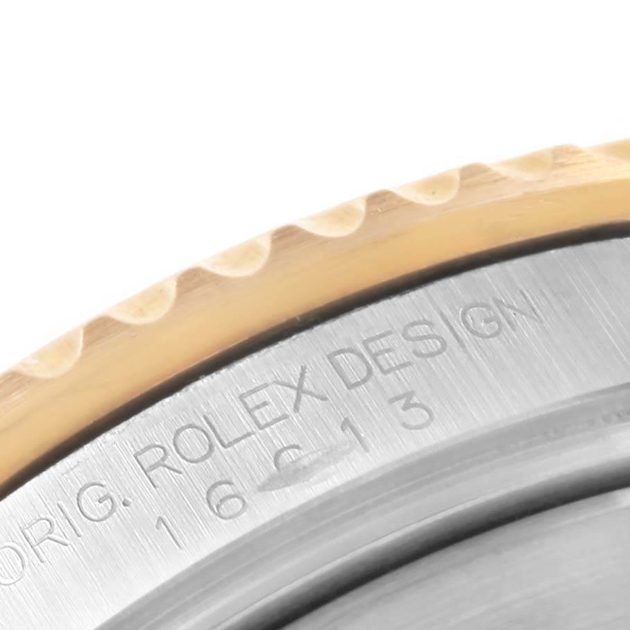 This image shows a close-up of the bezel and engraved edge of a Rolex Submariner 16613 Men's Steel and Gold (two tone) Blue Dial 16613 Men's Steel and Gold (two tone) Blue Dial watch.