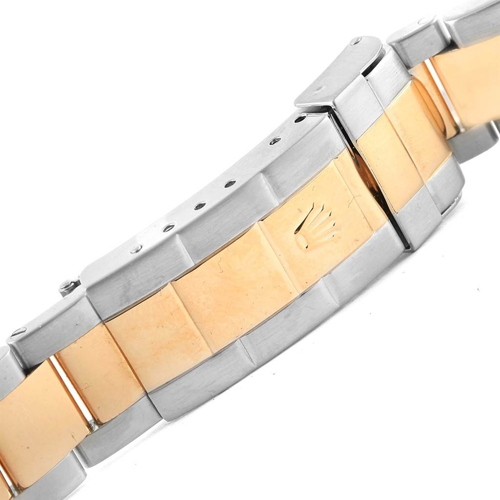 The image shows the clasp and links of a Rolex Submariner 16613 Men's Steel and Gold (two tone) Grey Dial 16613 Men's Steel and Gold (two tone) Grey Dial watch bracelet, featuring a combination of gold and stainless steel.
