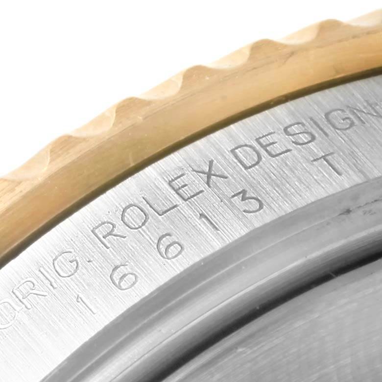 This image shows a close-up of the bezel and part of the engraved text on the case of a Rolex Submariner 16613 Men's Steel and Gold (two tone) Grey Dial 16613 Men's Steel and Gold (two tone) Grey Dial watch.