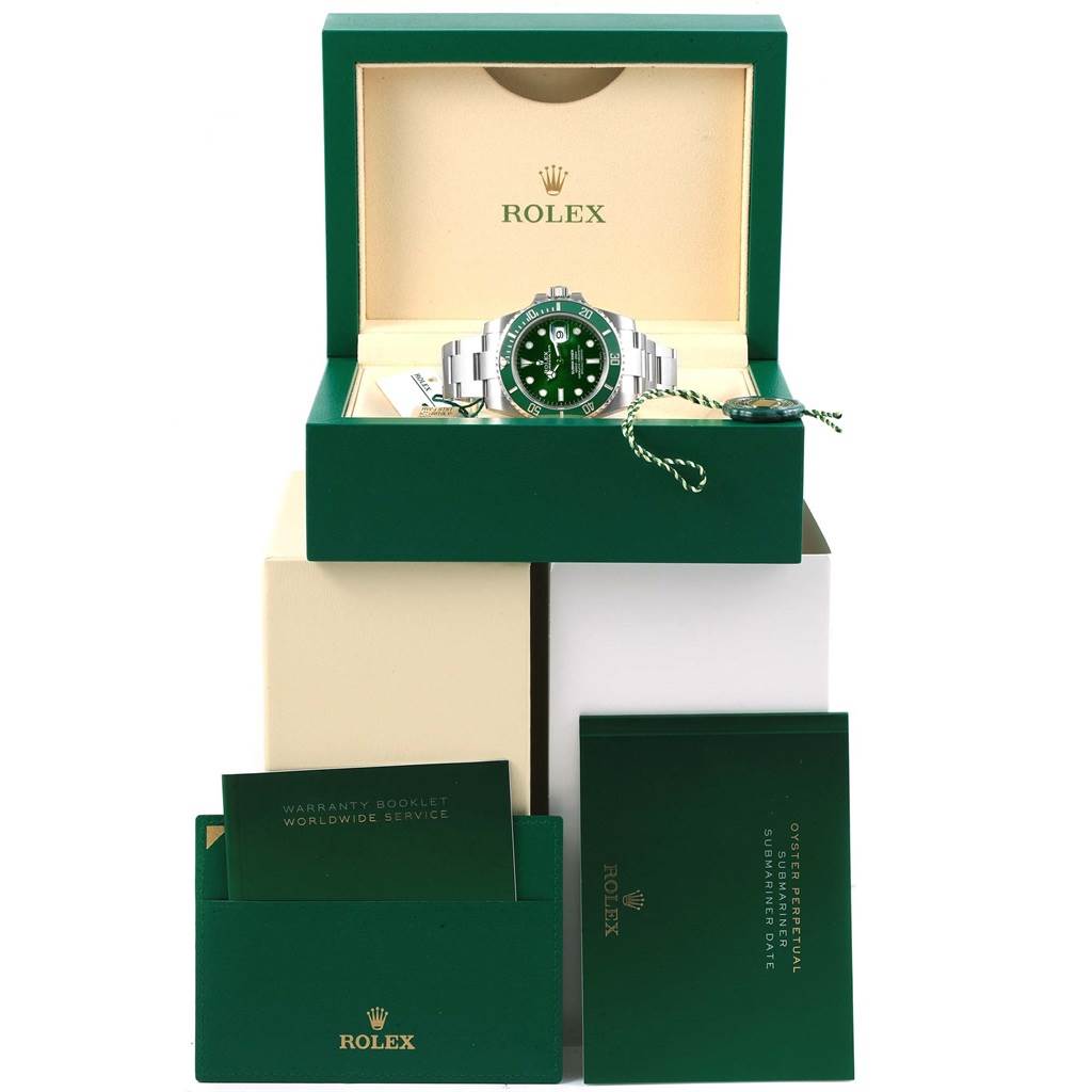 The image shows a Rolex Submariner 116610LV Men
s Stainless Steel Green Dial 116610LV Men
s Stainless Steel Green Dial watch displayed in its box, with manuals and warranty booklets visible in front.