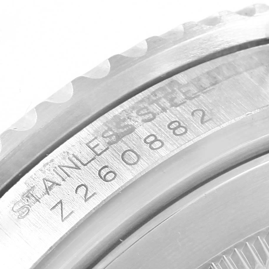 The image shows a close-up angle of the case back and bezel grooves of a Rolex Submariner 16610LV Men's Stainless Steel Black Dial 16610LV Men's Stainless Steel Black Dial, highlighting its stainless steel material and serial number.