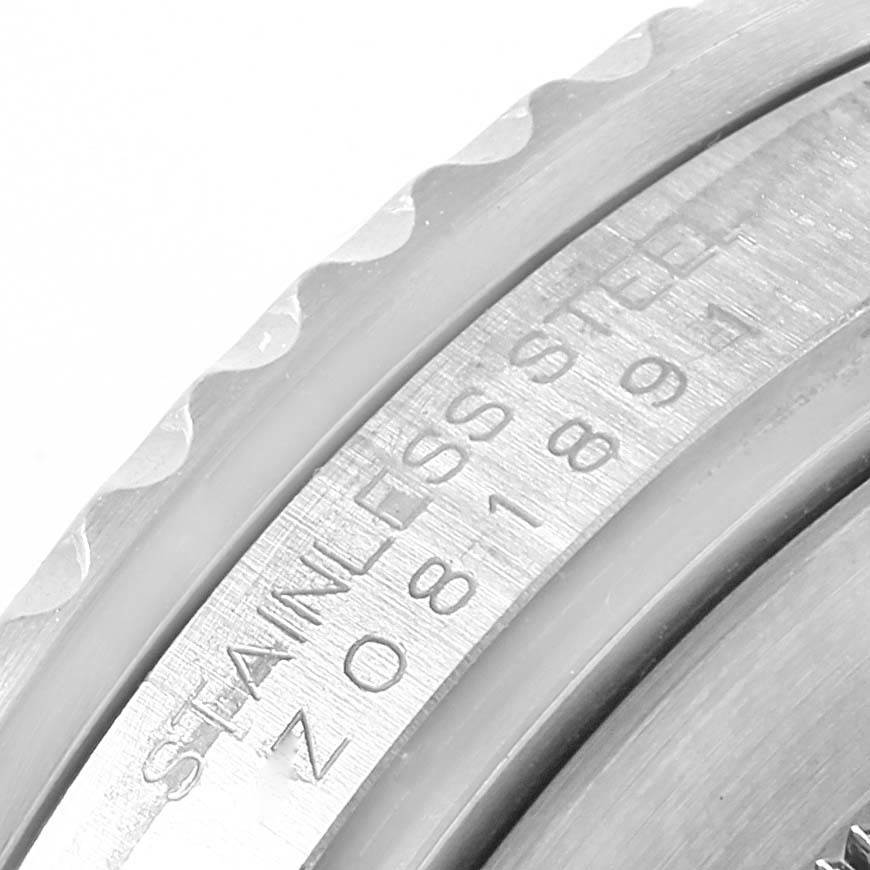 This close-up angle of the Rolex Submariner 16610 Men's Stainless Steel Black Dial 16610 Men's Stainless Steel Black Dial watch shows the engraved serial number and the edge of the bezel.