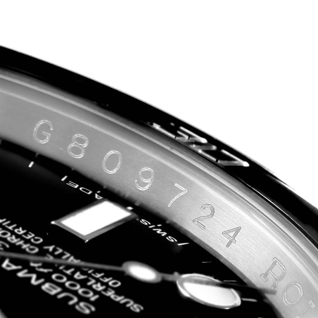 This close-up image shows the engraved inner bezel and part of the dial of a Rolex Submariner 114060 Men's Stainless Steel Black Dial 114060 Men's Stainless Steel Black Dial watch.