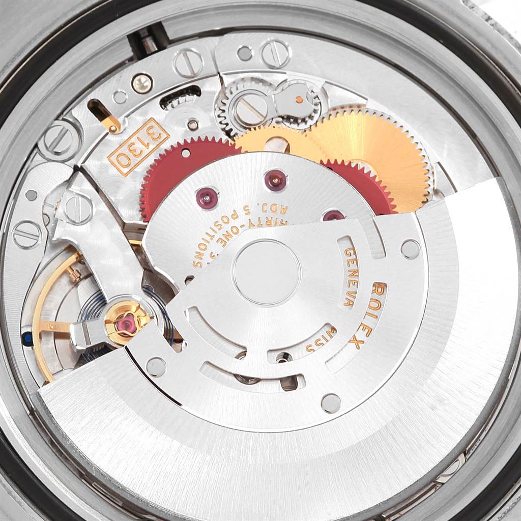 The image shows a close-up of the Rolex Submariner 114060 Men's Stainless Steel Black Dial 114060 Men's Stainless Steel Black Dial's movement, highlighting the intricate gears and inner mechanisms.