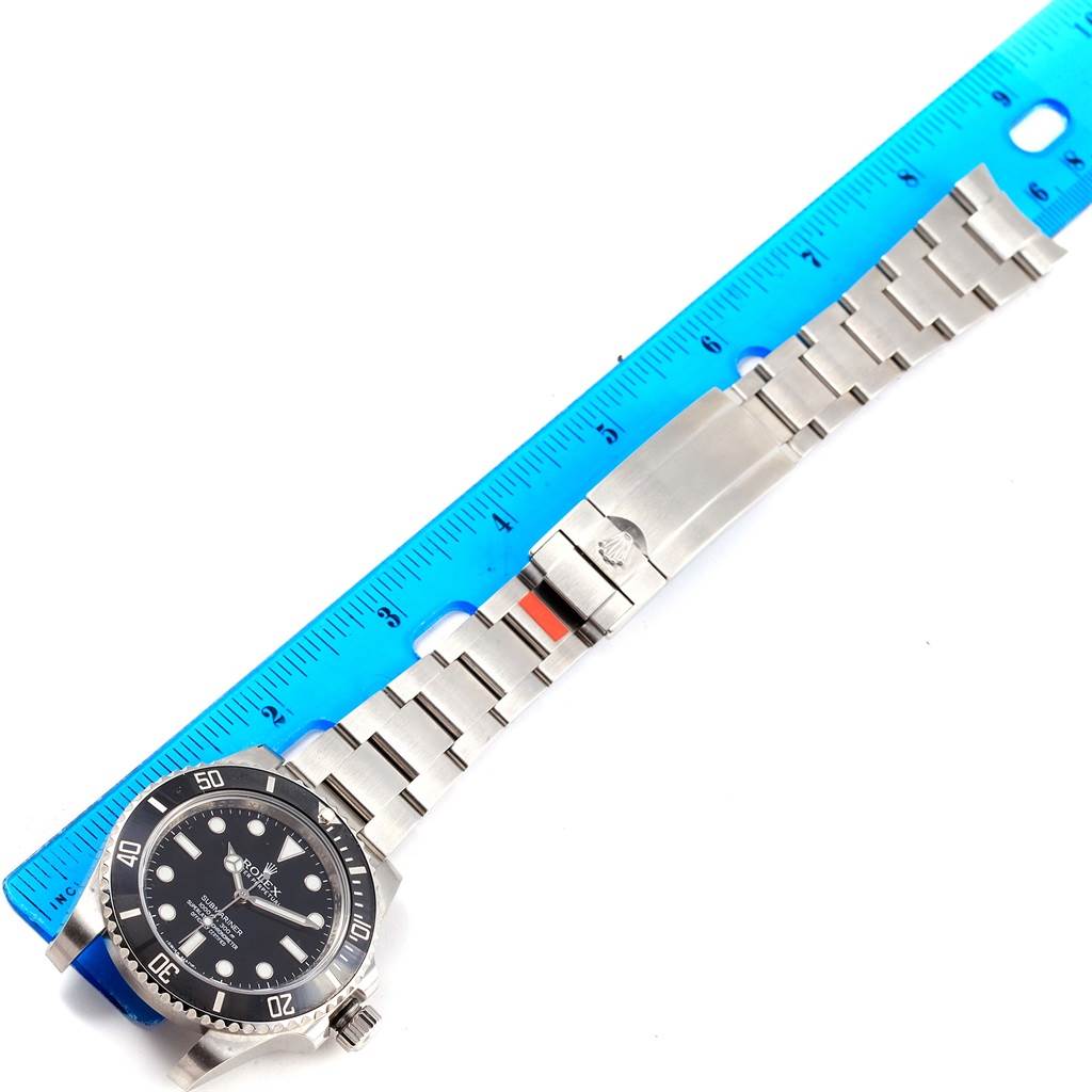 The image shows a top-down view of a Rolex Submariner 114060 Men's Stainless Steel Black Dial 114060 Men's Stainless Steel Black Dial watch, featuring the watch face, bezel, and bracelet positioned alongside a ruler for measurement.