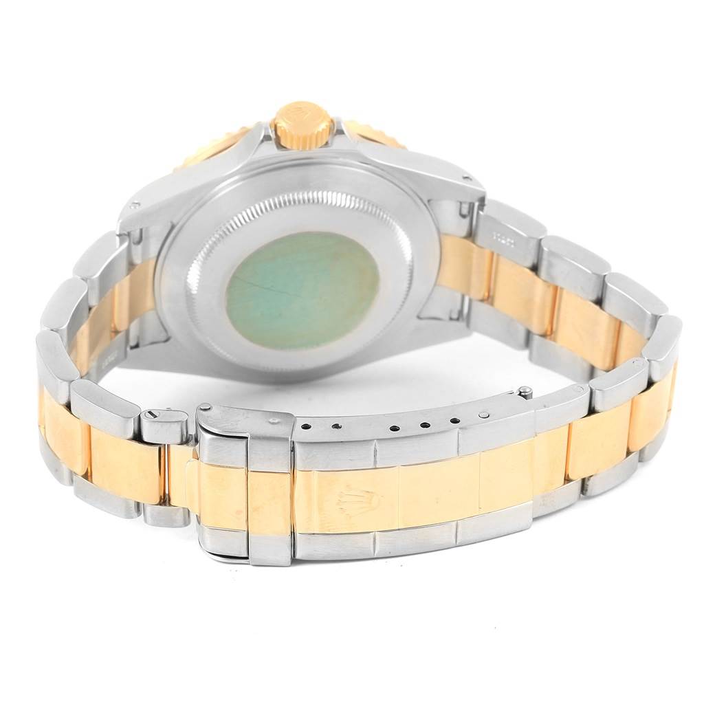 The image shows the back view of a Rolex Submariner 16613 Men's Steel and Gold (two tone) Blue Dial 16613 Men's Steel and Gold (two tone) Blue Dial watch, highlighting its clasp, case back, and bracelet.