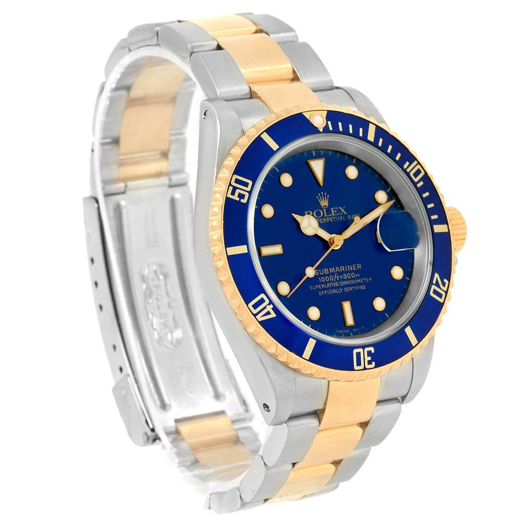 This image shows a Rolex Submariner 16613 Men's Steel and Gold (two tone) Blue Dial 16613 Men's Steel and Gold (two tone) Blue Dial watch at an angle displaying its blue dial, two-tone gold and silver bracelet, and bezel.