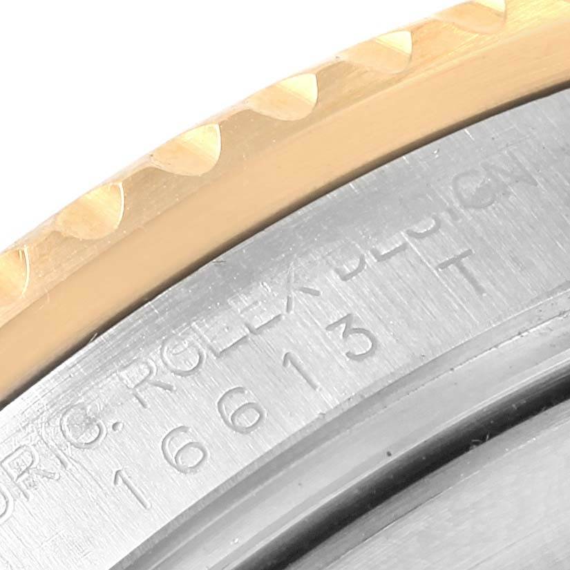 This image shows a close-up of the bezel and engraved caseback of a Rolex Submariner 16613 Men's Steel and Gold (two tone) Champagne Dial 16613 Men's Steel and Gold (two tone) Champagne Dial model watch.