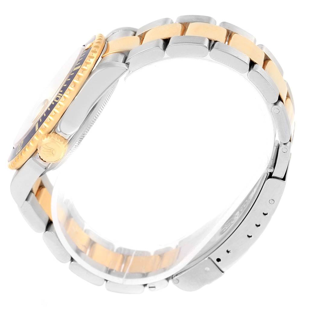 This image shows a side view of a Rolex Submariner 16613 Men's Steel and Gold (two tone) Champagne Dial 16613 Men's Steel and Gold (two tone) Champagne Dial, focusing on the case, crown, and two-tone bracelet.