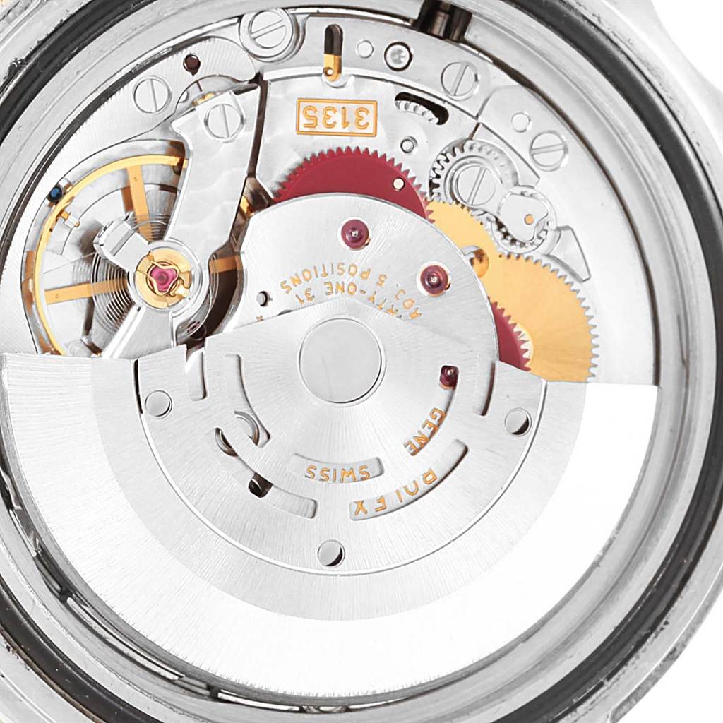 The image shows the inner mechanism of the Rolex Submariner 16613 Men's Steel and Gold (two tone) Champagne Dial 16613 Men's Steel and Gold (two tone) Champagne Dial watch, focusing on the movement and gears.
