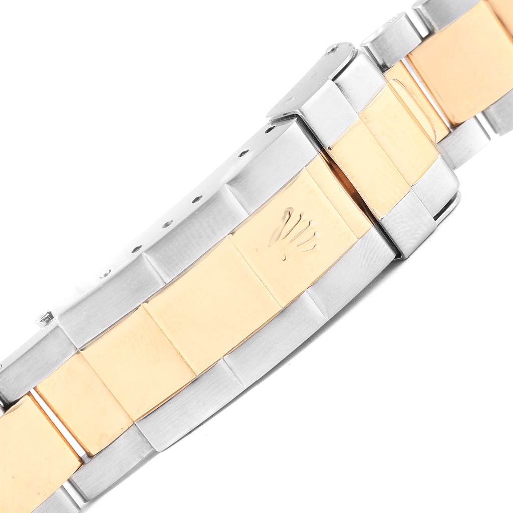 This image shows the clasp and part of the two-tone bracelet of a Rolex Submariner 16613 Men's Steel and Gold (two tone) Champagne Dial 16613 Men's Steel and Gold (two tone) Champagne Dial watch.