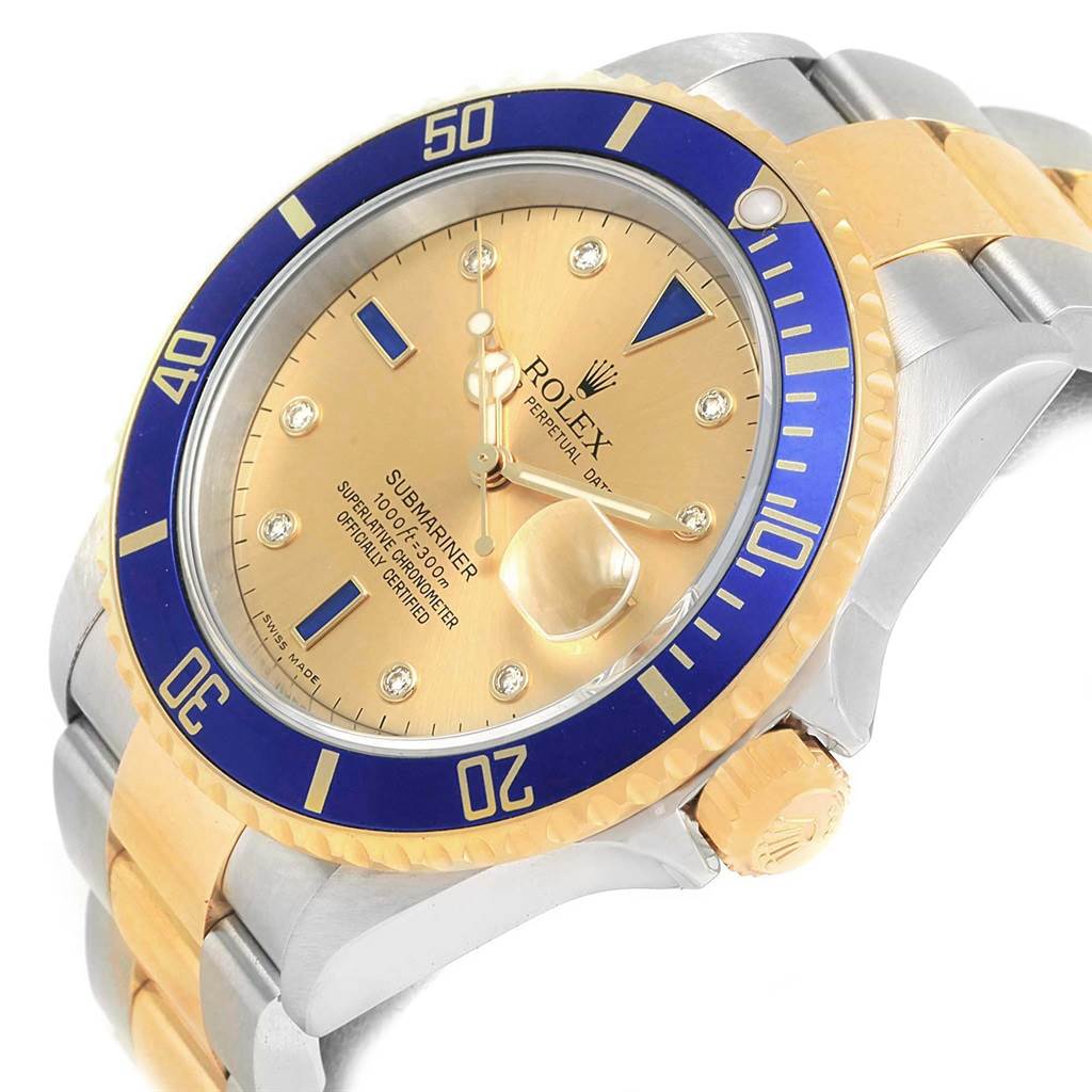 This image shows a close-up, angled view of a Rolex Submariner 16613 Men's Steel and Gold (two tone) Champagne Dial 16613 Men's Steel and Gold (two tone) Champagne Dial watch, highlighting its blue bezel, gold dial, and two-tone bracelet.