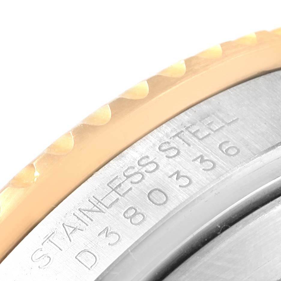 This image shows a close-up angle of the bezel and caseback edge of a Rolex Submariner 16613 Men's Steel and Gold (two tone) Champagne Dial 16613 Men's Steel and Gold (two tone) Champagne Dial, revealing the stainless steel engraving and part of the serial number.
