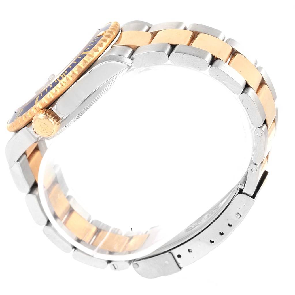 The image shows a side view of a Rolex Submariner 16613 Men's Steel and Gold (two tone) Blue Dial 16613 Men's Steel and Gold (two tone) Blue Dial watch, focusing on the band and crown.