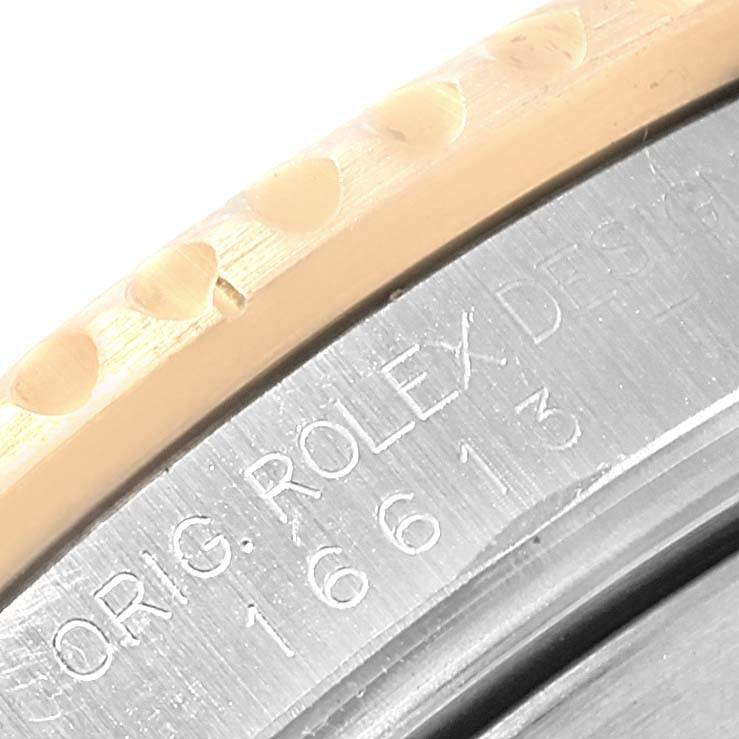 The image shows a close-up of the bezel and engraved side of the Rolex Submariner 16613 Men's Steel and Gold (two tone) Blue Dial 16613 Men's Steel and Gold (two tone) Blue Dial model.