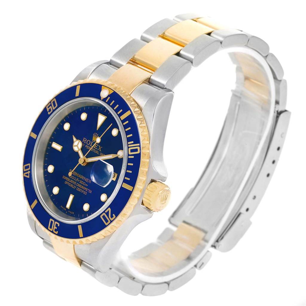 The image shows a Rolex Submariner 16613 Men's Steel and Gold (two tone) Blue Dial 16613 Men's Steel and Gold (two tone) Blue Dial watch at an angle highlighting its blue dial, gold bezel, and two-tone metal bracelet.