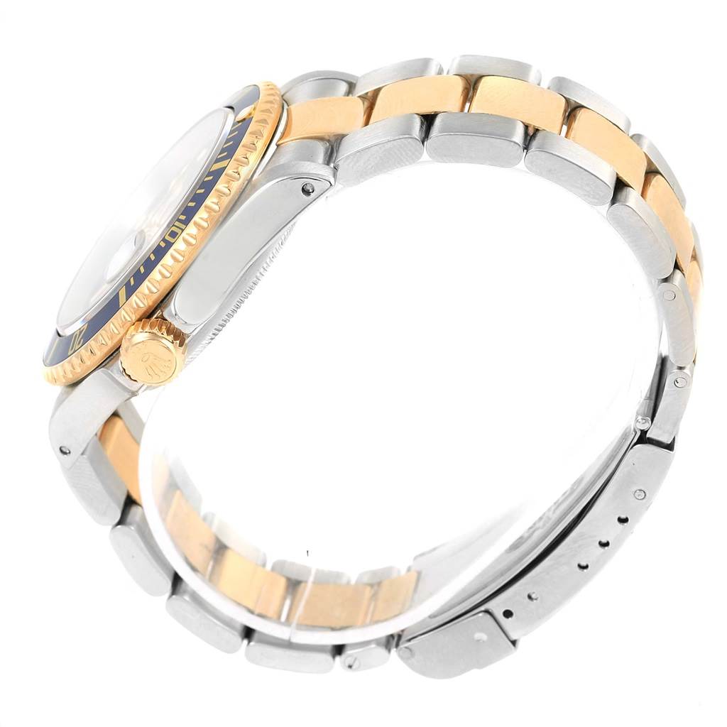 The image shows a side view of the Rolex Submariner 16613 Men's Steel and Gold (two tone) Blue Dial 16613 Men's Steel and Gold (two tone) Blue Dial watch, highlighting its crown, bezel, and two-tone bracelet.