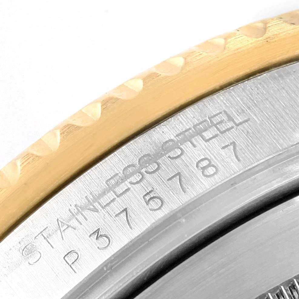 The image shows a close-up of the case back edge of a Rolex Submariner 16613 Men's Steel and Gold (two tone) Blue Dial 16613 Men's Steel and Gold (two tone) Blue Dial, highlighting the engraved serial number on the stainless steel.