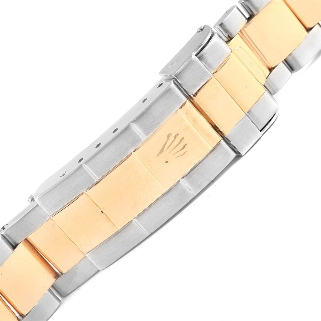 This image shows a close-up of the bracelet clasp of a Rolex Submariner 16613 Men's Steel and Gold (two tone) Blue Dial 16613 Men's Steel and Gold (two tone) Blue Dial watch.